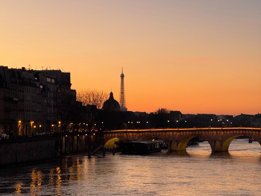 vibrant orange sunset in paris with eiffel tower in the background